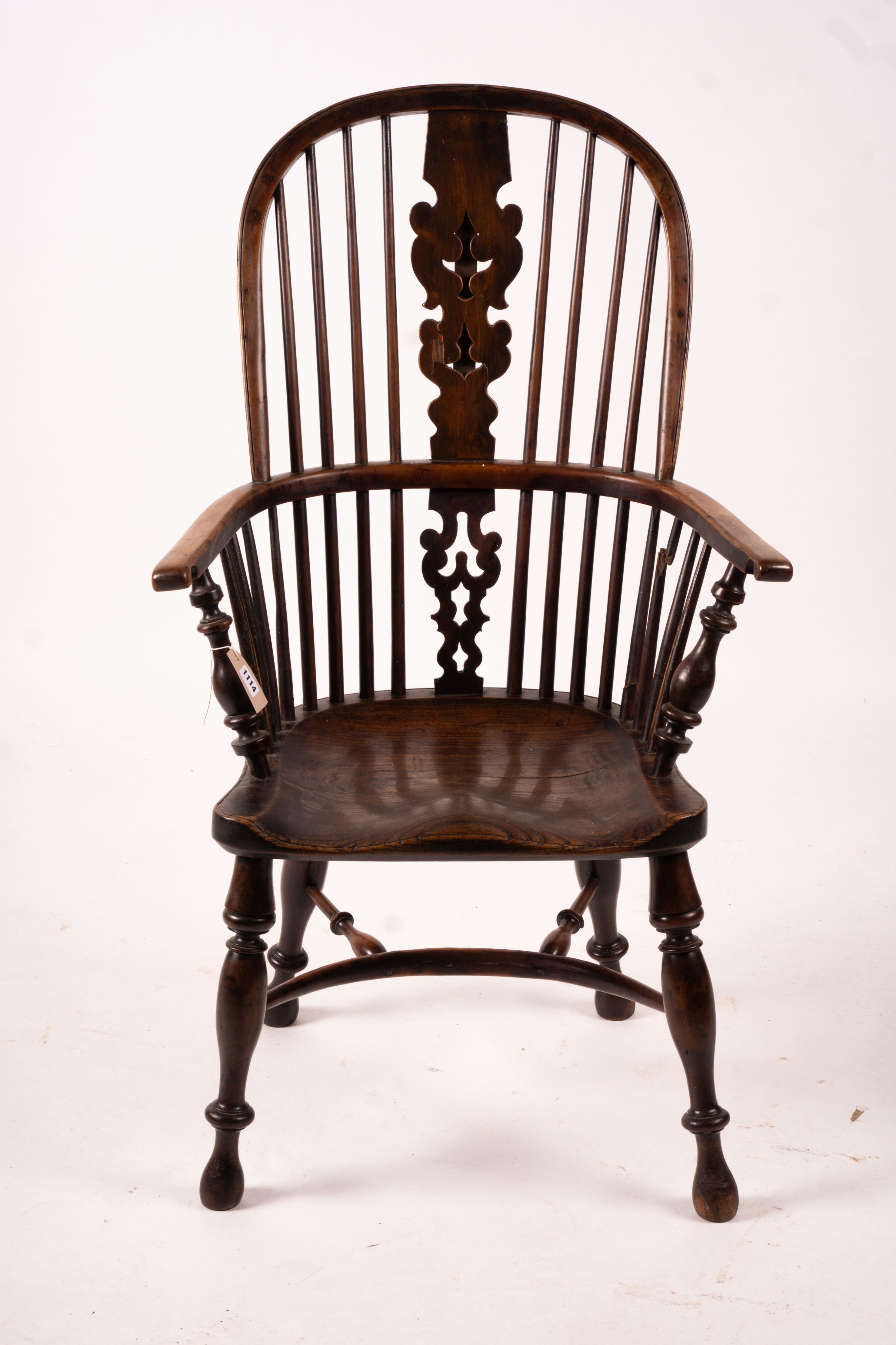 A mid 19th century yew and elm Yorkshire area Windsor armchair with saddle-seat and crinoline stretcher, width 63cm, depth 47cm, height 110cm